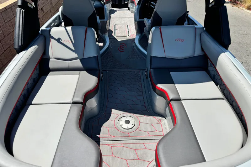 Slide: The Image of 2023 Manitou 25 XT RFXW boat interior with gray and red seating, modern design. - 19