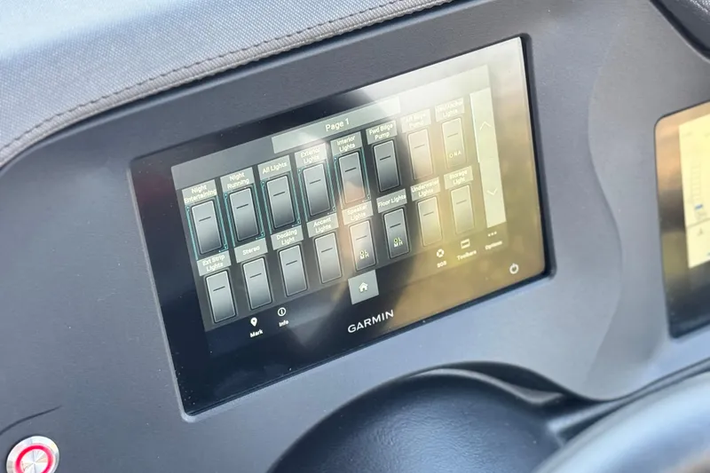 Slide: The Image of Garmin touchscreen control panel on 2023 Manitou 25 XT RFXW boat dashboard. - 25