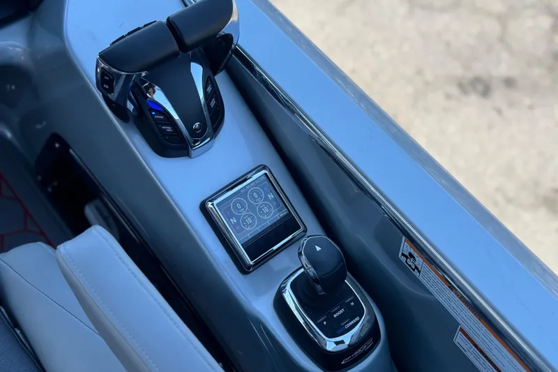 Slide: The Image of 2023 Manitou 25 XT RFXW boat control panel with joystick and touchscreen display. - 27