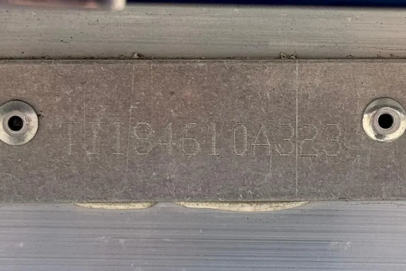 Slide: The Image of 2023 Manitou 25 XT RFXW serial number plate with engraved details. - 28