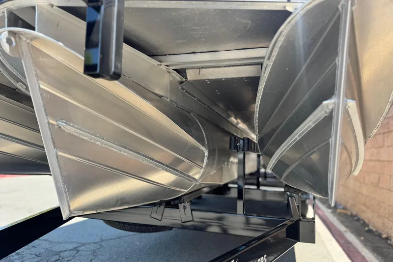 Slide: The Image of 2023 Manitou 25 XT RFXW pontoon boat underside view, showcasing aluminum construction. - 4