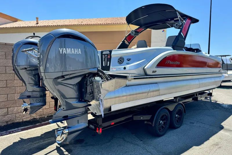 Slide: The Image of 2023 Manitou 25 XT RFXW pontoon boat with dual Yamaha outboard engines on a trailer. - 6