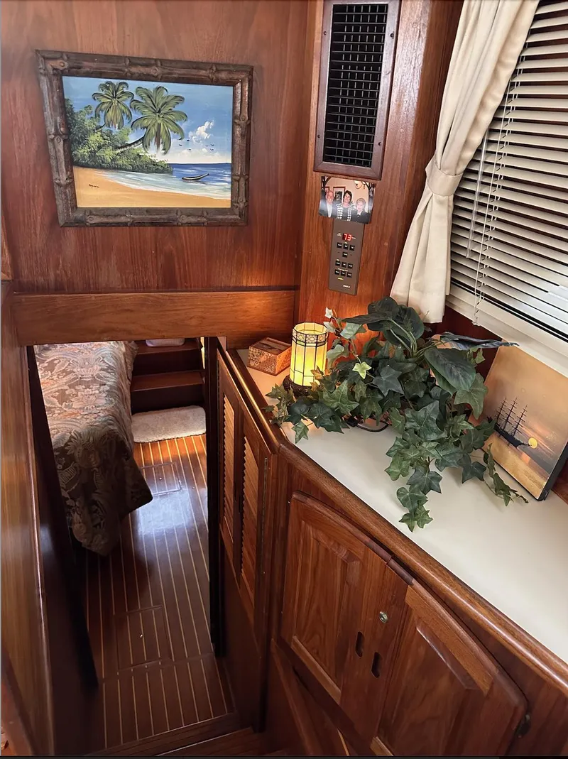 Slide: The Image of Interior of 1987 Californian 48 Cockpit Motor Yacht with wood paneling and tropical decor. - 13