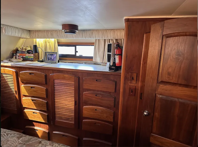 Slide: The Image of 1987 Californian 48 Cockpit Motor Yacht interior with wooden cabinetry and window. - 15