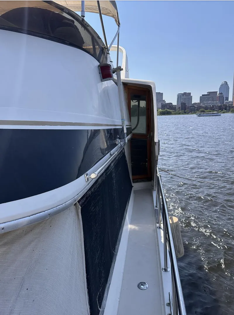 Slide: The Image of 1987 Californian 48 Cockpit Motor Yacht docked by city skyline. - 19