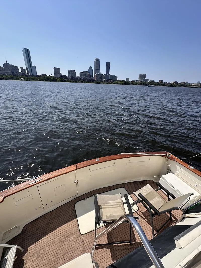Slide: The Image of 1987 Californian 48 Cockpit Motor Yacht with city skyline view in the background. - 21