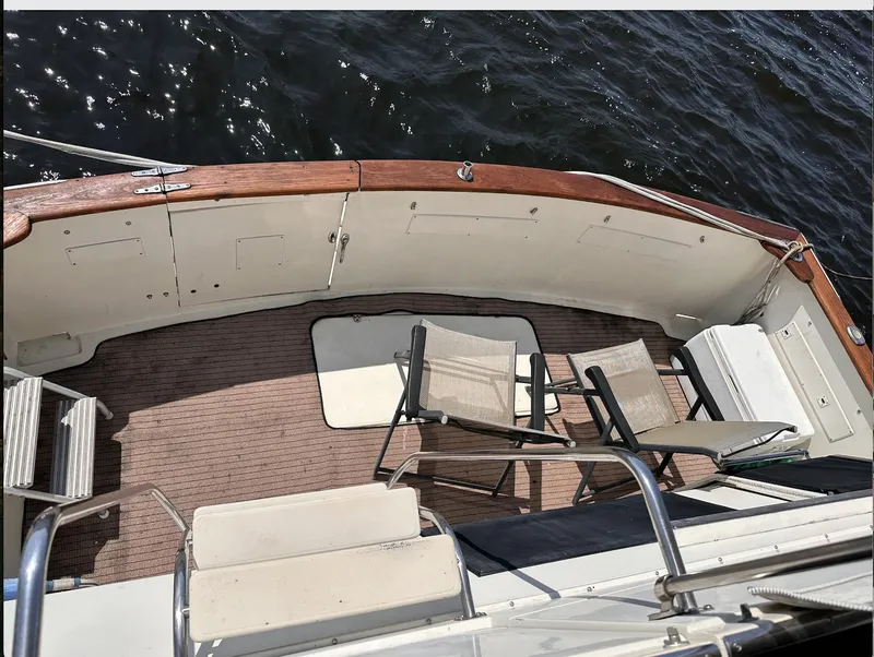 Slide: The Image of 1987 Californian 48 Cockpit Motor Yacht deck with chairs overlooking water. - 26