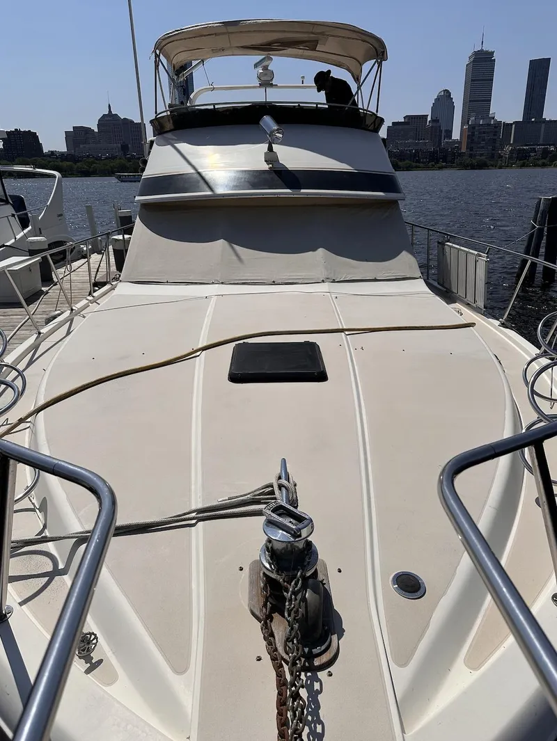 Slide: The Image of 1987 Californian 48 Cockpit Motor Yacht docked with city skyline in background. - 27