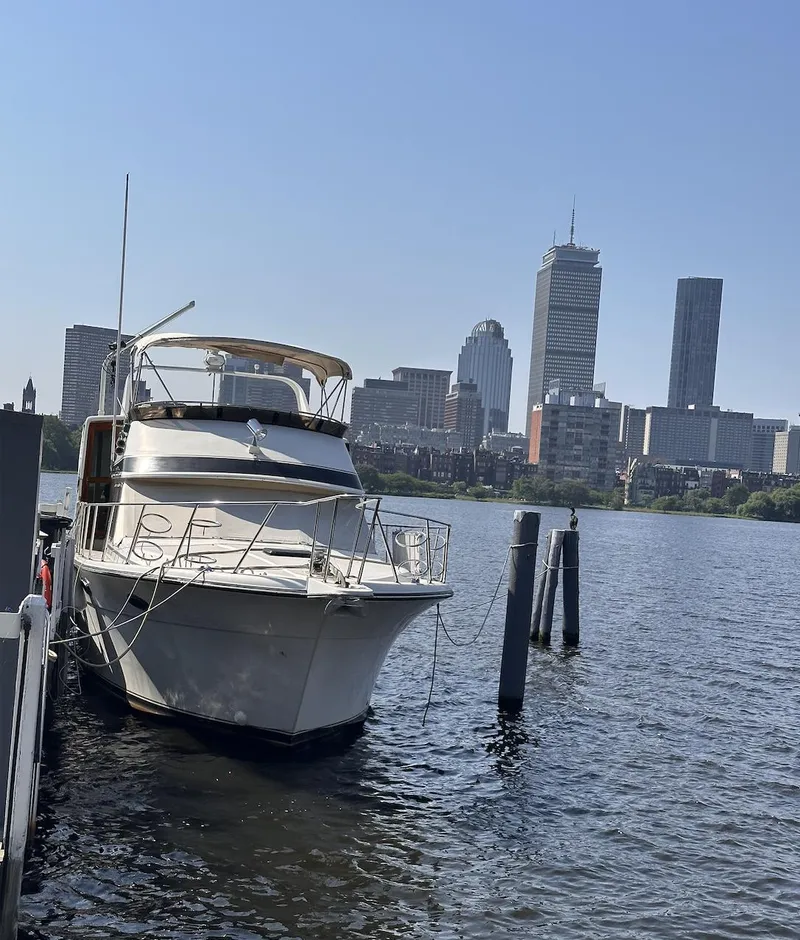 Slide: The Image of 1987 Californian 48 Cockpit Motor Yacht docked with city skyline in background. - 28