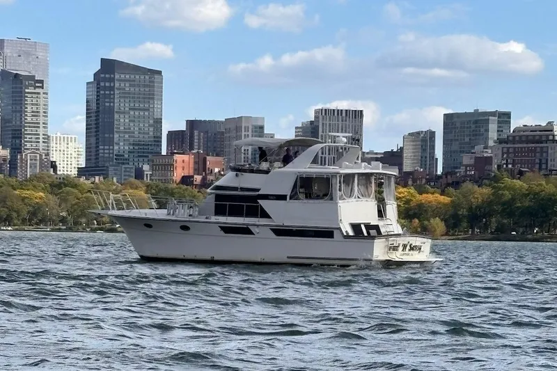 Slide: The Image of 1987 Californian 48 Cockpit Motor Yacht on water with city skyline background. - 29
