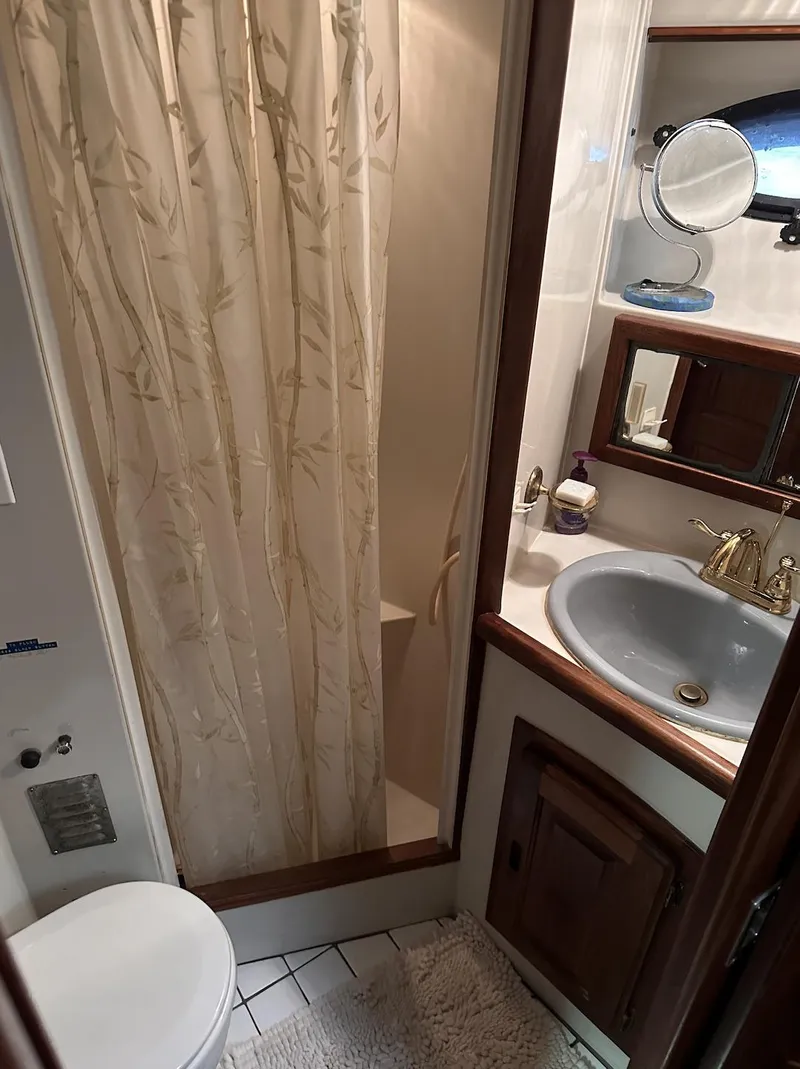 Slide: The Image of 1987 Californian 48 Cockpit Motor Yacht bathroom with shower, sink, and mirror. - 8