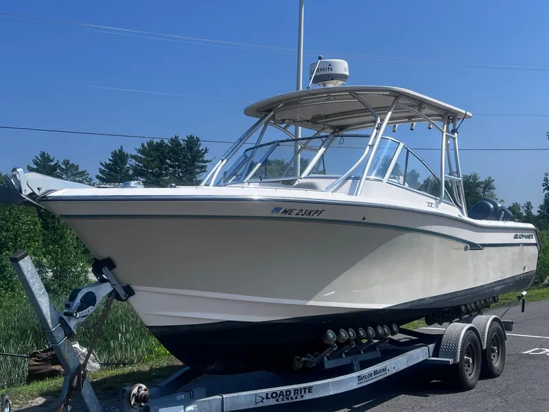 The Image of 2012 Grady-White Freedom 275 boat on trailer under clear blue sky. - 11