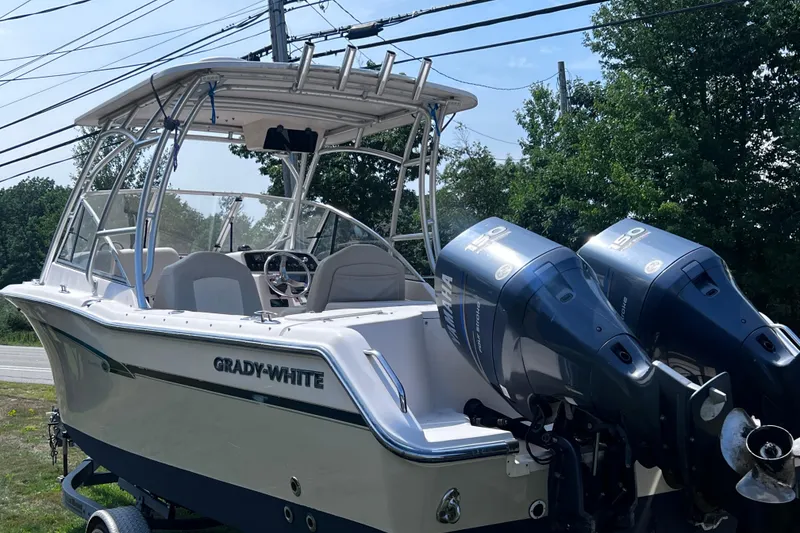 Slide: The Image of 2012 Grady-White Freedom 275 boat with dual Yamaha engines, parked outdoors. - 14
