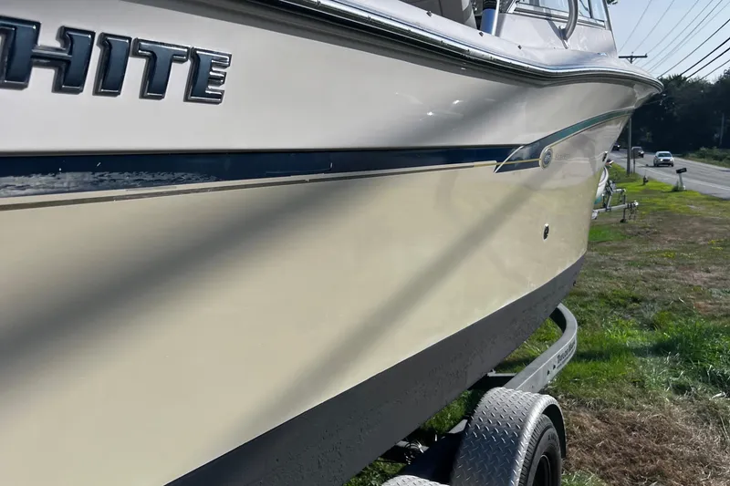 Slide: The Image of 2012 Grady-White Freedom 275 boat on trailer, side view, parked near road. - 16