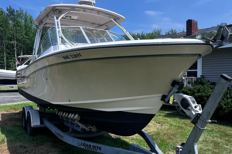 Slide: The Image of 2012 Grady-White Freedom 275 boat on trailer, parked outdoors. - 21