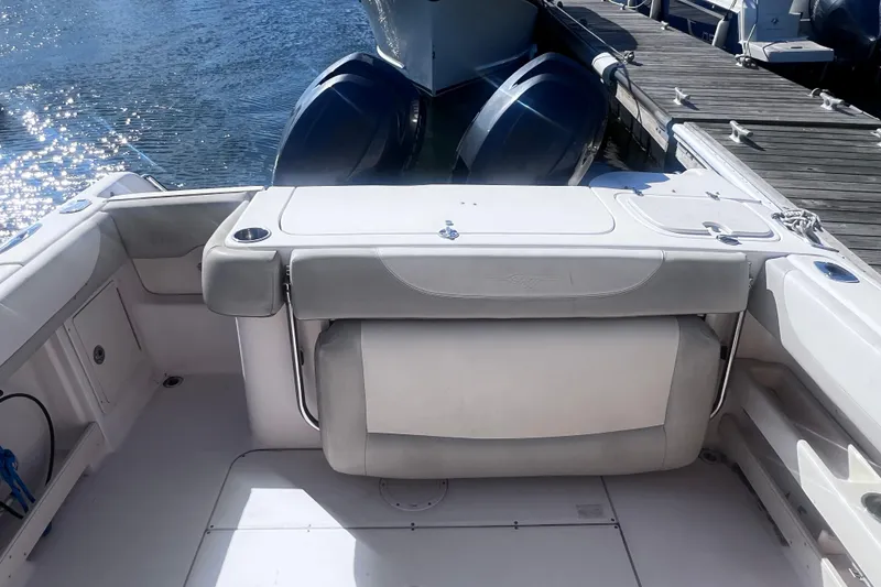Slide: The Image of 2012 Grady-White Freedom 275 boat interior with seating and twin engines at dock. - 25