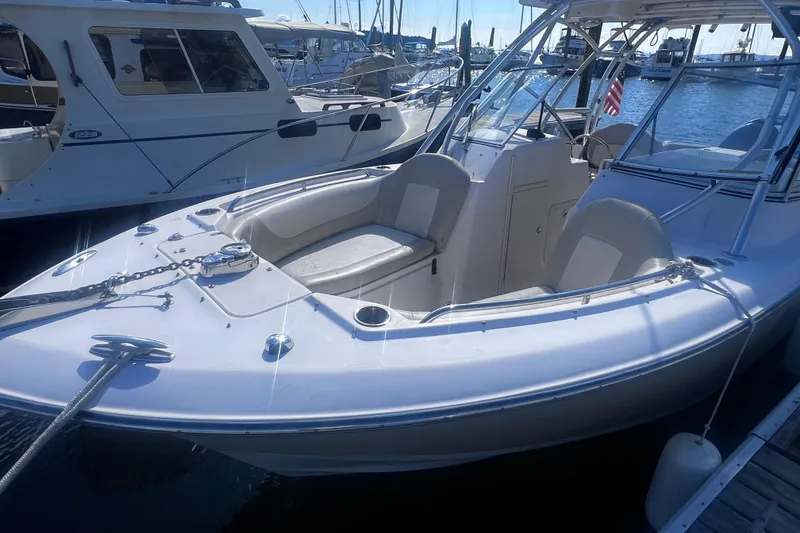 Slide: The Image of 2012 Grady-White Freedom 275 boat docked at marina, featuring spacious seating and sleek design. - 29