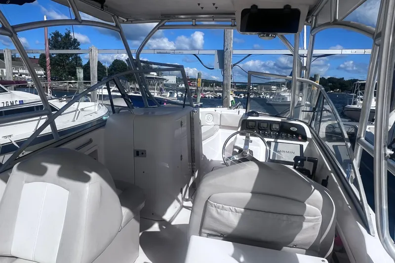 Slide: The Image of 2012 Grady-White Freedom 275 boat interior with steering wheel and dashboard at marina. - 33