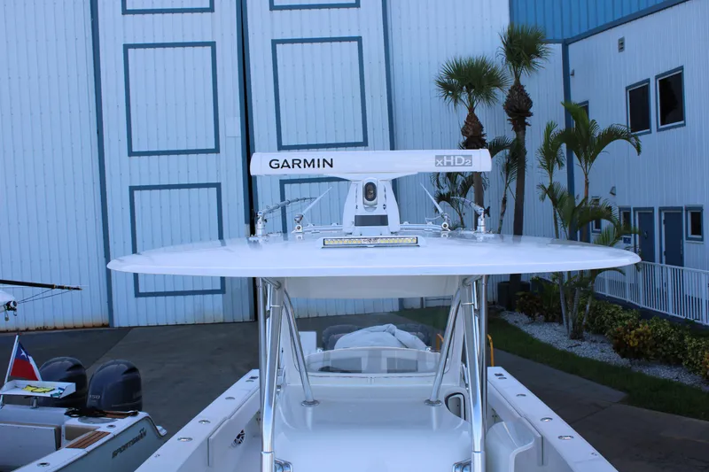 Slide: The Image of 1998 Venture 34 Open boat with Garmin radar, docked near palm trees. - 11