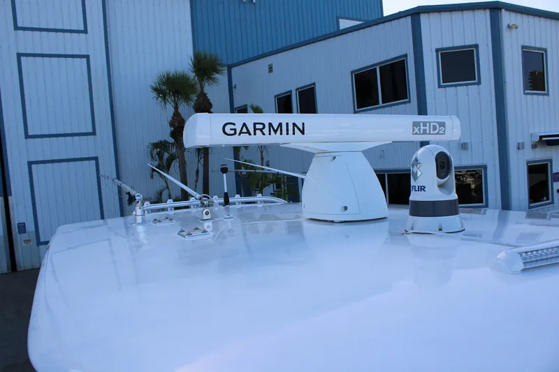 Slide: The Image of Radar and camera equipment on a 1998 Venture 34 Open boat, near a blue building. - 13