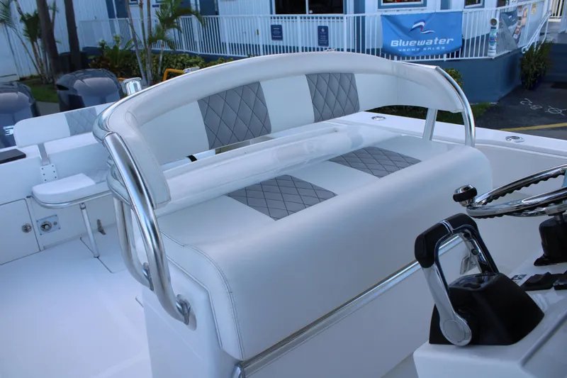Slide: The Image of 1998 Venture 34 Open boat interior with white and gray seating, steering wheel, and controls. - 14