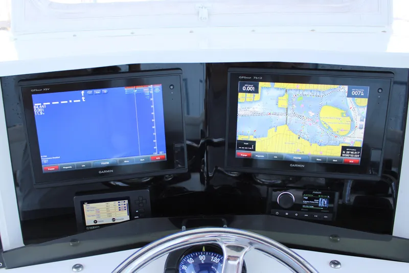 Slide: The Image of Boat dashboard with dual Garmin displays on a 1998 Venture 34 Open. - 17