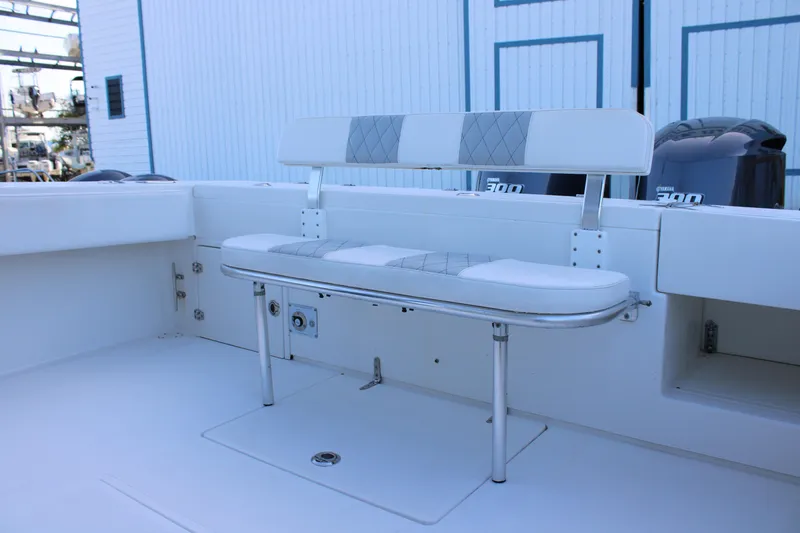 Slide: The Image of 1998 Venture 34 Open boat interior with cushioned seating and Yamaha engines. - 22