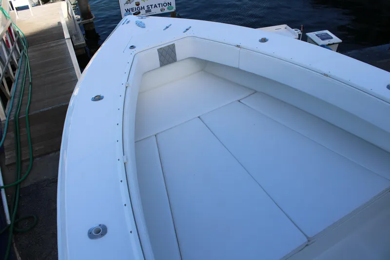 Slide: The Image of 1998 Venture 34 Open boat deck with cushioned seating at dockside. - 25