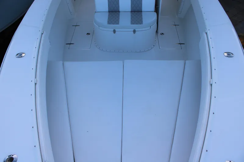 Slide: The Image of 1998 Venture 34 Open boat interior with white seating and storage compartments. - 27