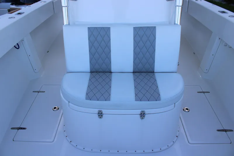 Slide: The Image of White cushioned seat with diamond pattern on a 1998 Venture 34 Open boat. - 28
