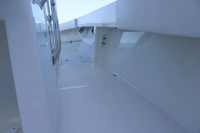Slide: The Image of Interior view of a 1998 Venture 34 Open boat, showcasing sleek white surfaces. - 32