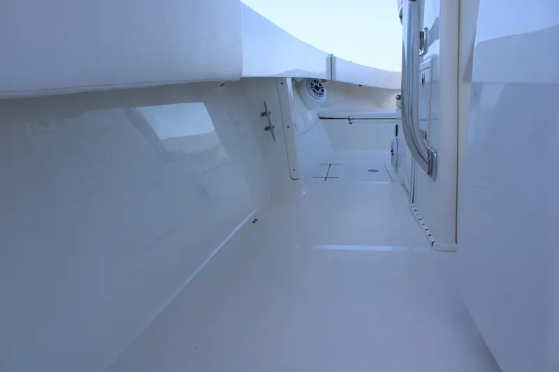 Slide: The Image of Interior view of a 1998 Venture 34 Open boat, showcasing sleek white surfaces. - 33