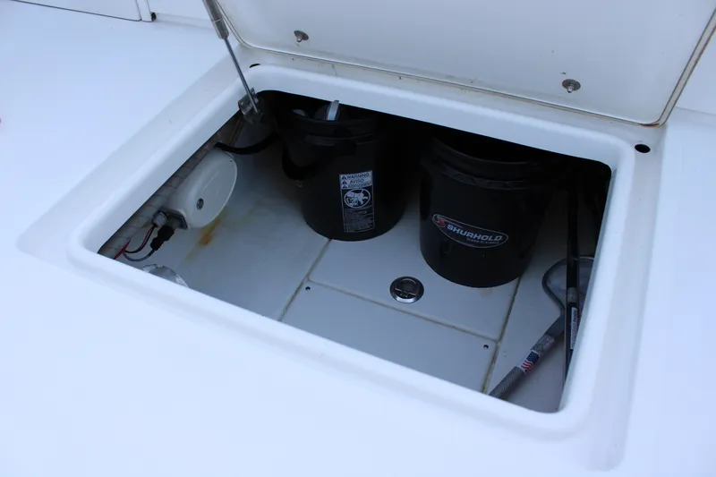 Slide: The Image of Open storage compartment on 1998 Venture 34 Open boat with cleaning supplies. - 36