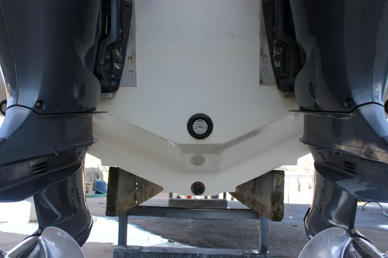 Slide: The Image of 1998 Venture 34 Open boat stern with dual outboard motors on a stand. - 37