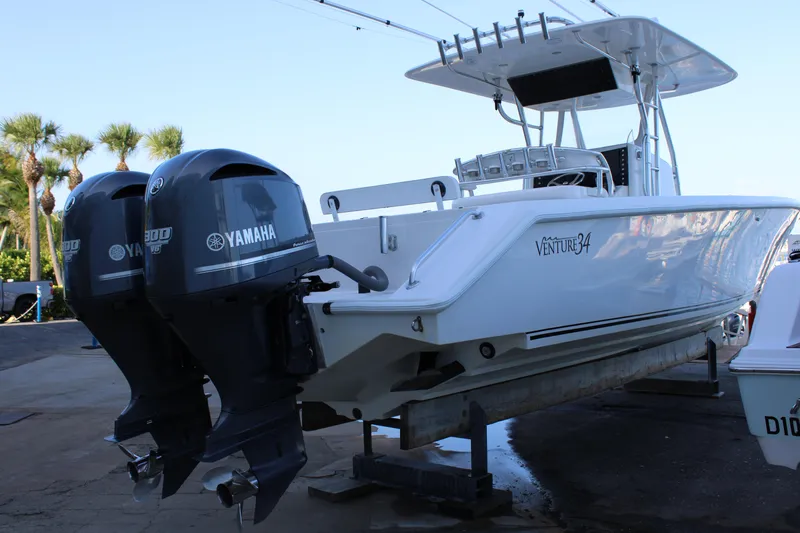 Slide: The Image of 1998 Venture 34 Open boat with twin Yamaha outboard engines on a trailer. - 7