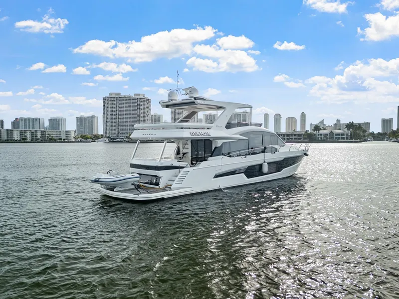 Slide: The Image of 2021 Galeon 680 Fly yacht cruising near city skyline under blue sky. - 28