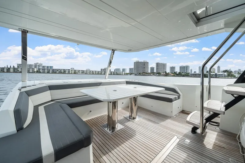 Slide: The Image of Luxurious 2021 Galeon 680 Fly yacht deck with seating, table, and waterfront city view. - 42