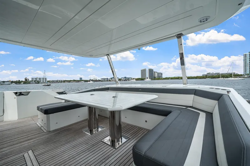 Slide: The Image of Luxurious 2021 Galeon 680 Fly yacht deck with seating, overlooking a scenic waterfront view. - 45