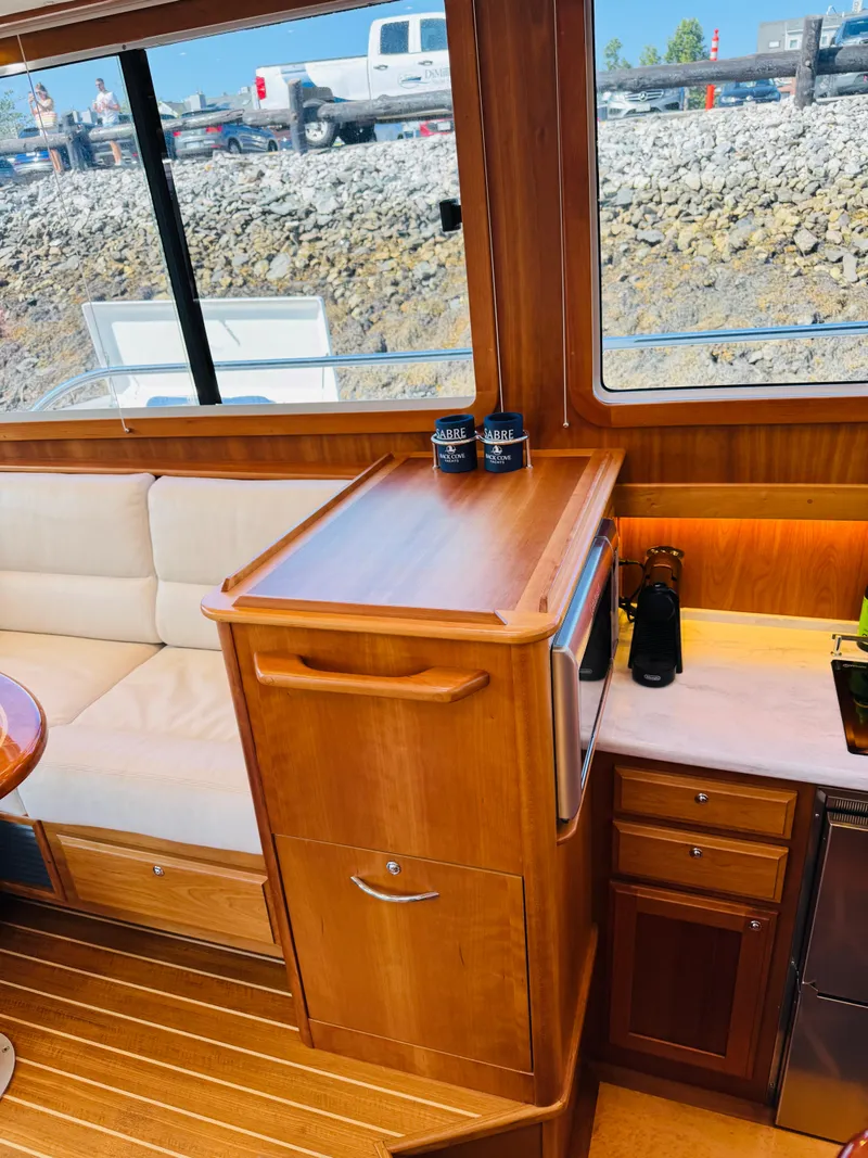 Slide: The Image of Interior of 2018 Sabre 42 Salon Express yacht with wooden cabinetry and seating. - 13