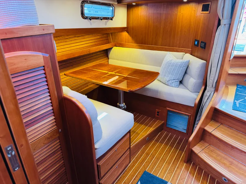 Slide: The Image of 2018 Sabre 42 Salon Express interior with wooden dining area and cushioned seating. - 16