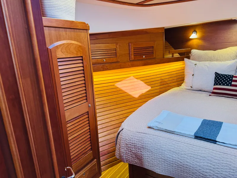 Slide: The Image of Cozy cabin interior of 2018 Sabre 42 Salon Express with wooden accents and soft lighting. - 19