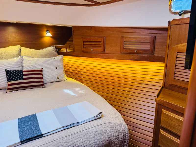 Slide: The Image of Luxurious cabin interior of 2018 Sabre 42 Salon Express with cozy bedding and warm lighting. - 20