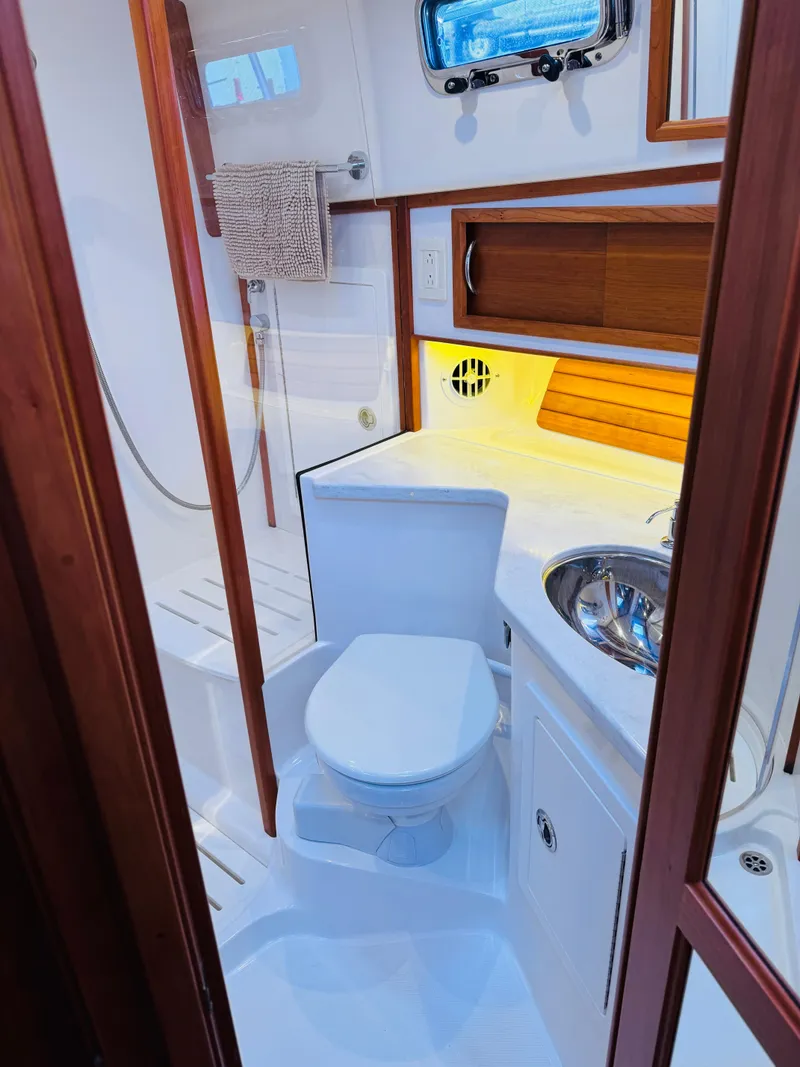 Slide: The Image of 2018 Sabre 42 Salon Express bathroom with modern fixtures and wooden accents. - 25