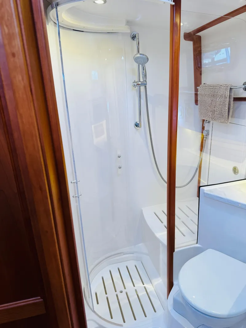 Slide: The Image of 2018 Sabre 42 Salon Express bathroom with shower and toilet, featuring wooden accents. - 26