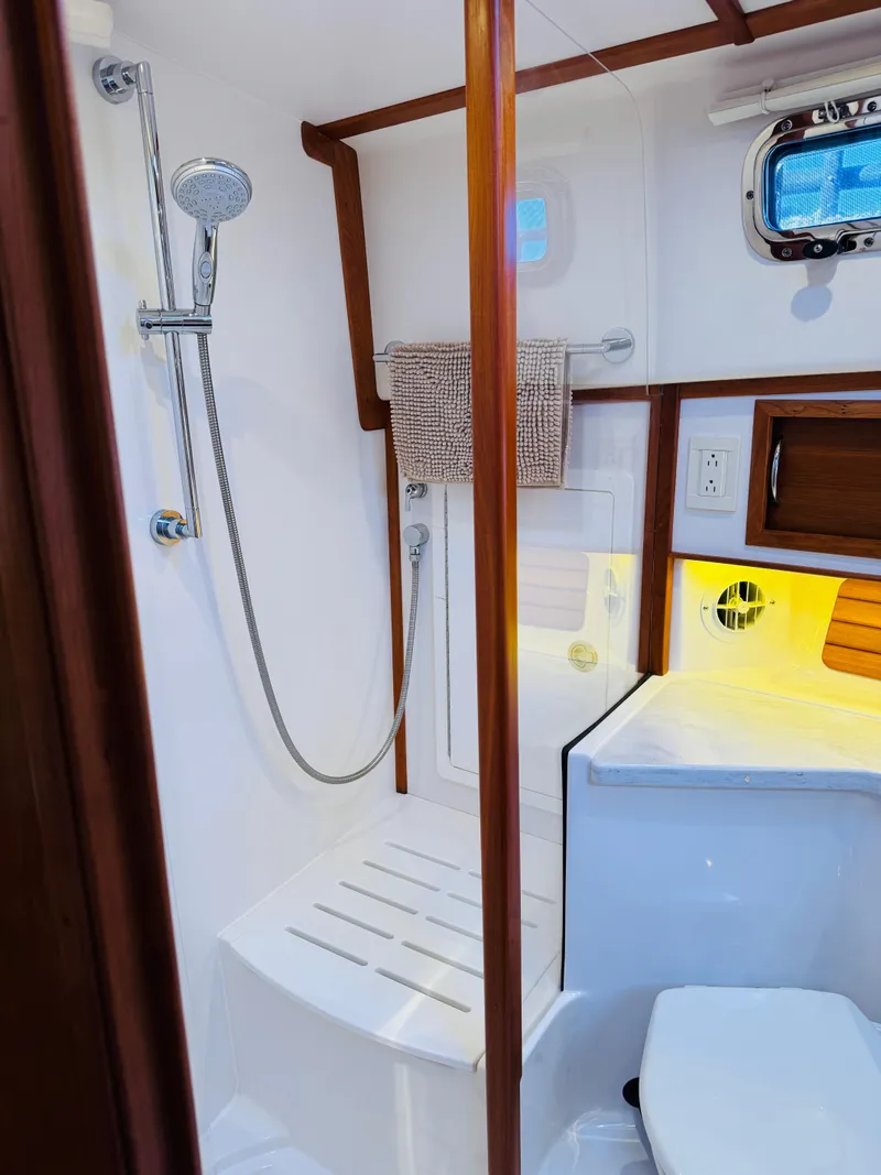 Slide: The Image of 2018 Sabre 42 Salon Express bathroom with shower, wooden accents, and modern fixtures. - 27
