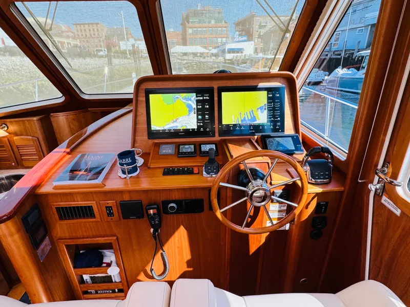 Slide: The Image of Helm of 2018 Sabre 42 Salon Express with navigation screens and wooden steering wheel. - 28