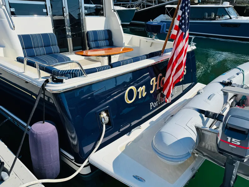 Slide: The Image of 2018 Sabre 42 Salon Express yacht with American flag, docked in marina. - 3