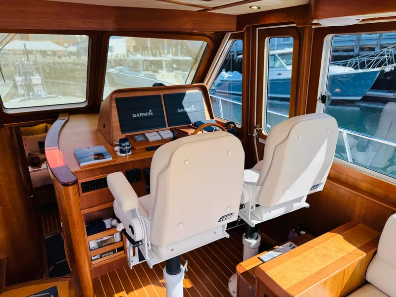 Slide: The Image of 2018 Sabre 42 Salon Express helm with Garmin navigation, featuring luxurious wood interior and dual captain chairs. - 30