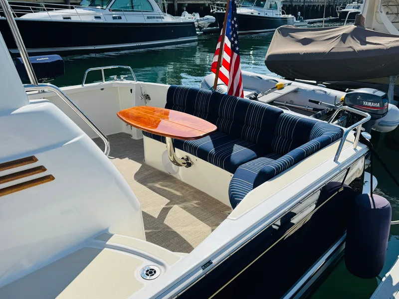Slide: The Image of 2018 Sabre 42 Salon Express yacht with elegant seating and table, docked in a marina. - 33