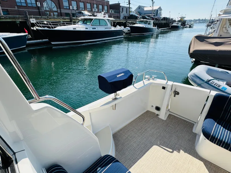 Slide: The Image of 2018 Sabre 42 Salon Express yacht docked in a marina, featuring a spacious deck area. - 35